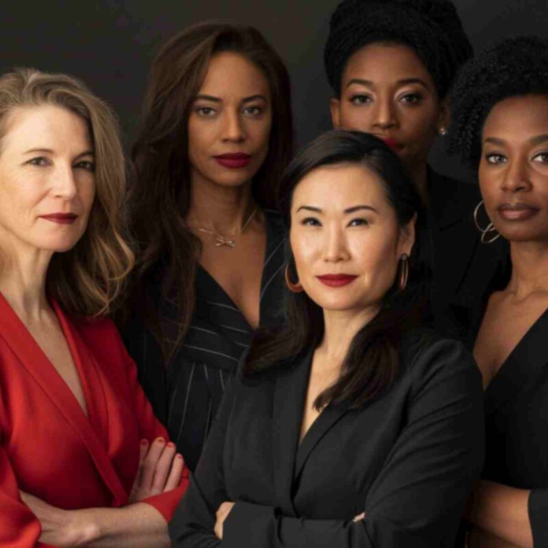 Diverse group of confident women leaders standing together, representing strength, leadership, and empowerment in a professional setting.