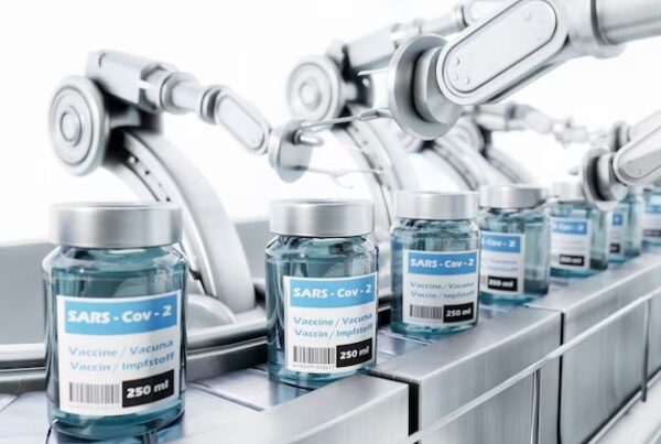 Vials labeled SARS-CoV-2 vaccine on an automated production line, representing innovative medical manufacturing technologies.