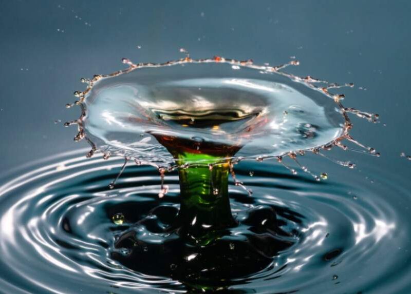 Close-up of a water droplet creating a splash, symbolizing the intricate and impactful nature of water research and innovation.