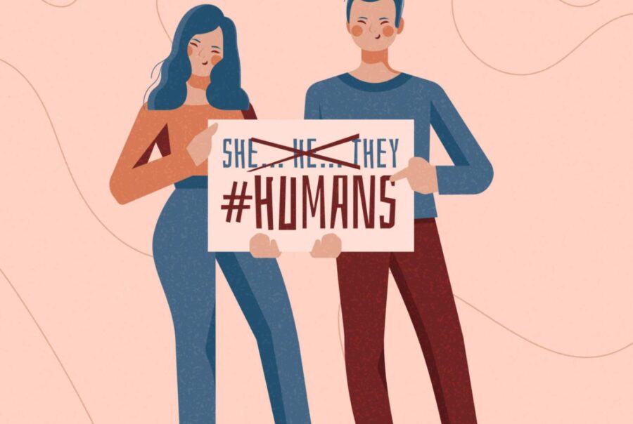 Two people holding a chart where "He," "She," and "They" are crossed out, and "Humans" is checked, representing a shift towards gender inclusivity and neutrality