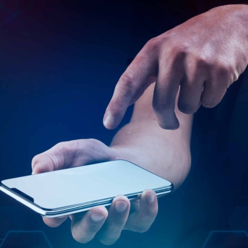 A person holding a smartphone displaying a health app, symbolizing mobile health technology for improving healthcare outcomes in low and middle-income countries (LMICs)