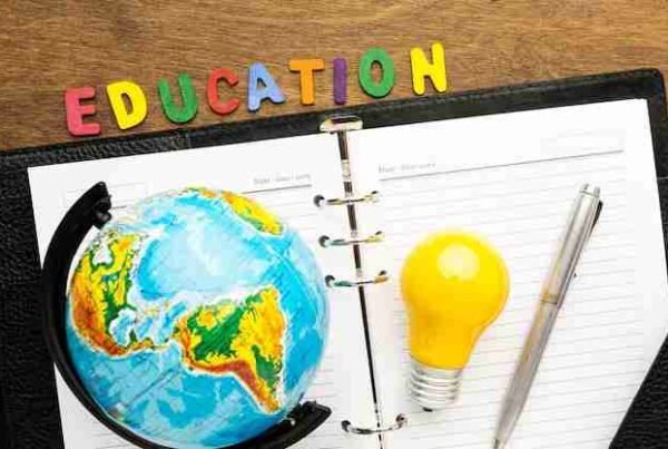 Colorful letters spelling 'Education' with a globe, lightbulb, and notebook, symbolizing innovation and global learning.